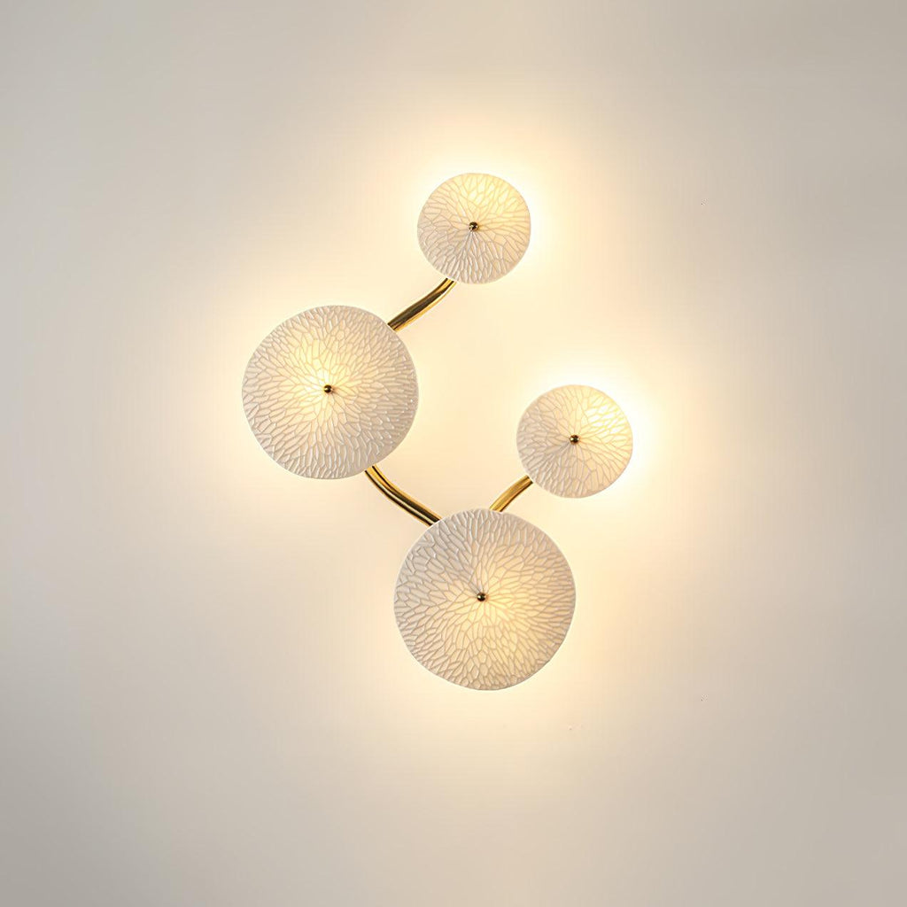 Lotus petal wall sconce glowing warm against a wall
