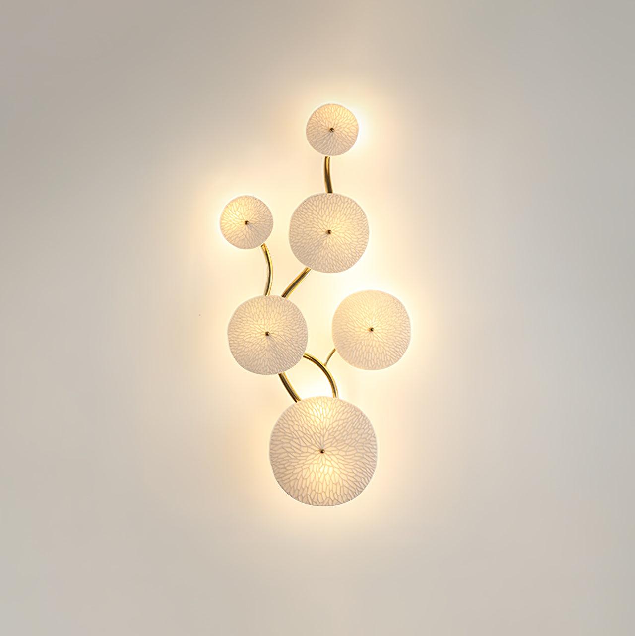 Gold-spine wall sconce with layered white ceramic lotus petals