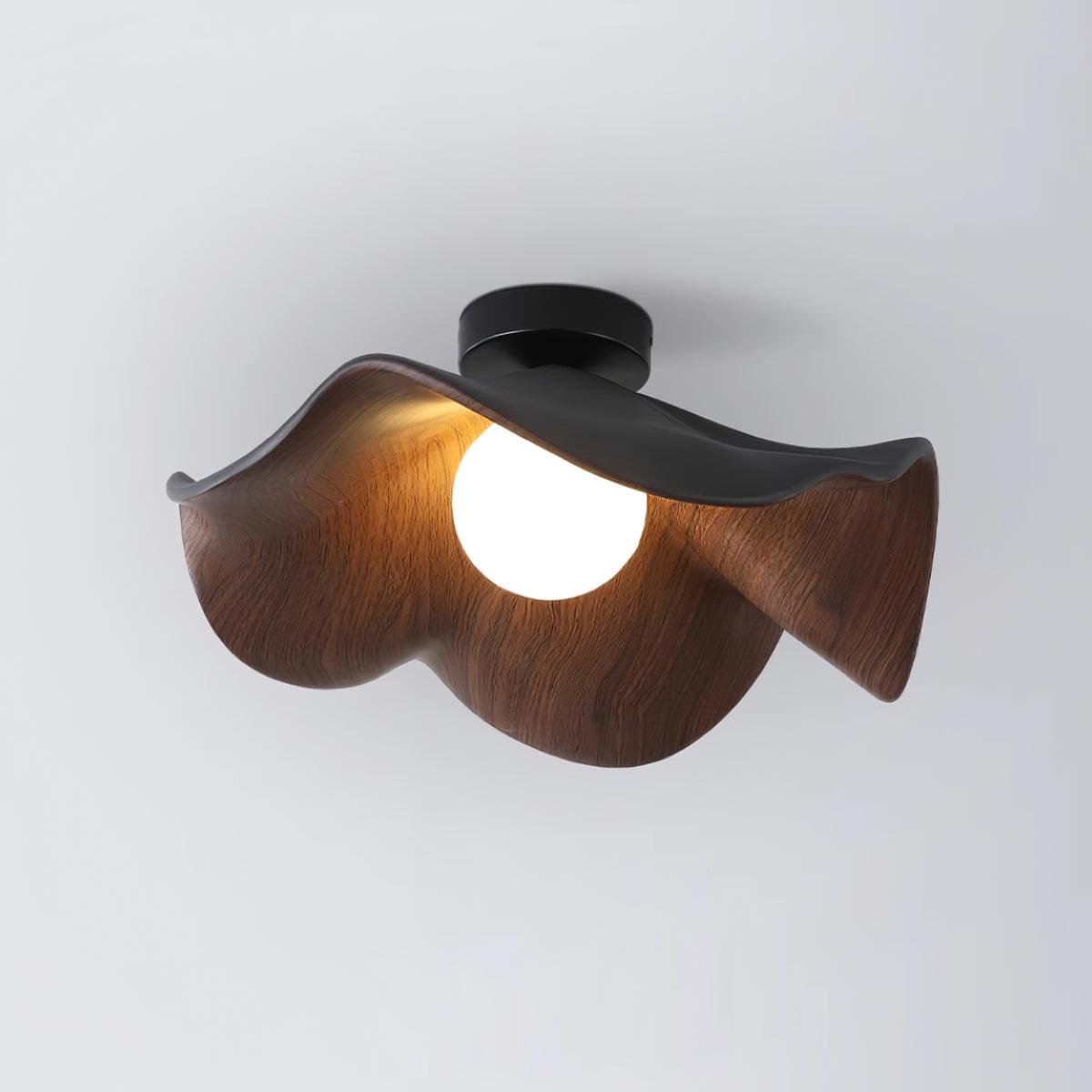 Sculptural leaf ceiling light with layered wood-grain petals lit warmly
