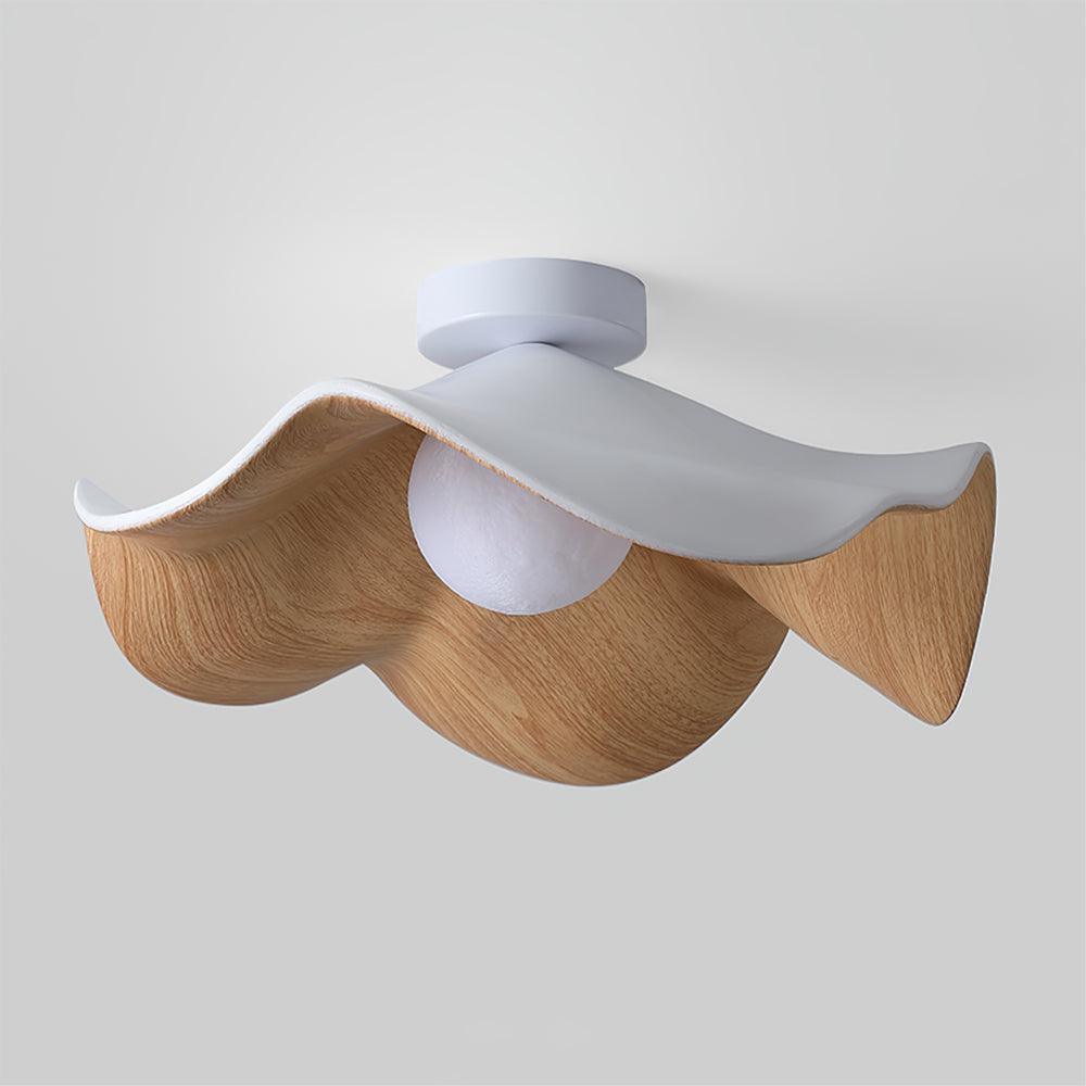 Wood-grain leaf flush mount light glowing in a soft warm tone