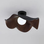 Lotus leaf ceiling light with wood-grain finish in a bedroom