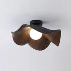 Sculptural leaf ceiling light with white shade and warm glow