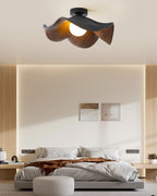 Layered lotus leaf ceiling light with warm wood-grain surface