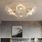 Frosted leaf glass ceiling light with gold body lit in a room