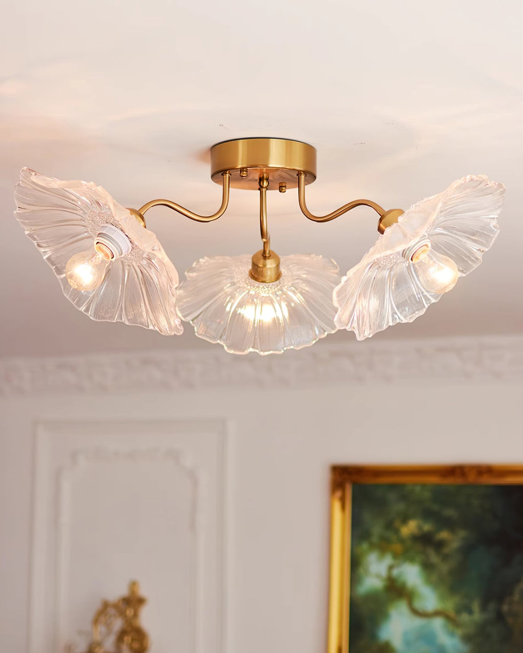 Frosted leaf glass ceiling light glowing above a dining setting
