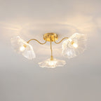 Frosted leaf glass ceiling light with gold body over a dining table