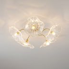 Frosted leaf glass ceiling light with gold hardware lit warmly