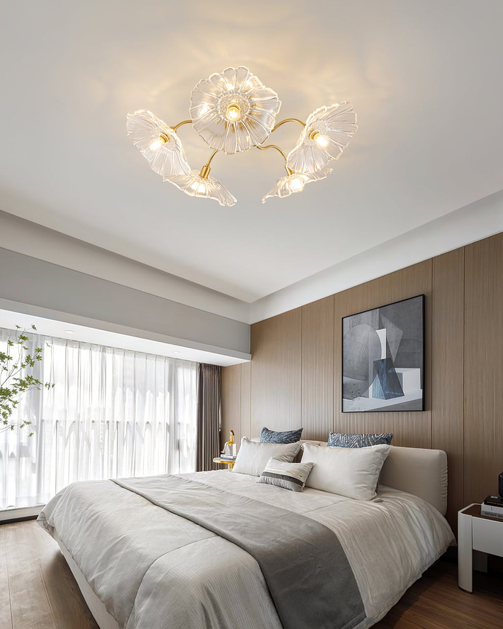 Frosted leaf glass ceiling light with gold hardware seen at an angle