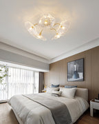Frosted leaf glass ceiling light with gold hardware seen at an angle