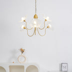 Leaf glass chandelier glowing over a dining table
