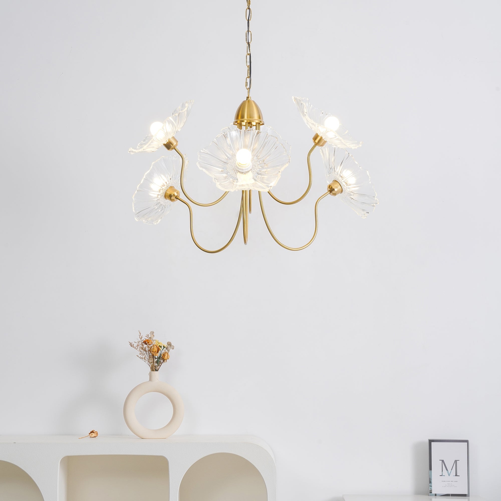 Leaf glass chandelier glowing over a dining table