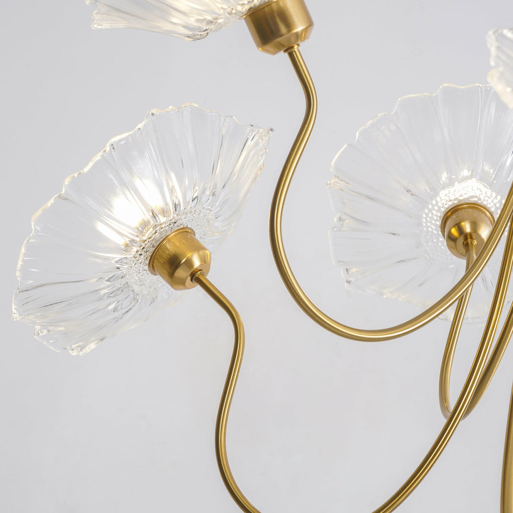 Frosted leaf glass chandelier glowing in a warm room