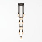 Product view of this Clérachic pendant, its marbled alabaster capsules staggered into a dense cluster on dark bronze rods.