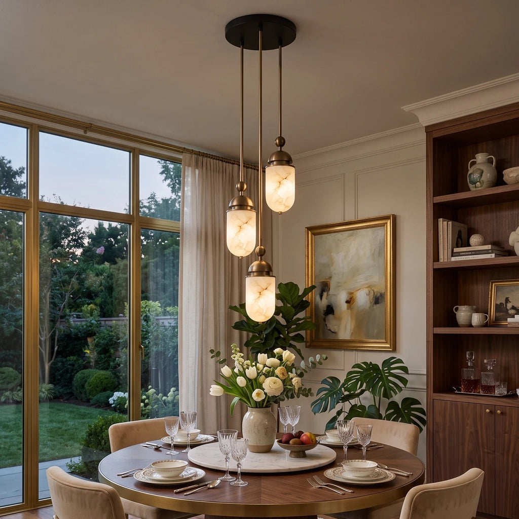 Beside glass doors opening to a garden, this Clérachic pendant's small cluster of capsules glows above a round table.