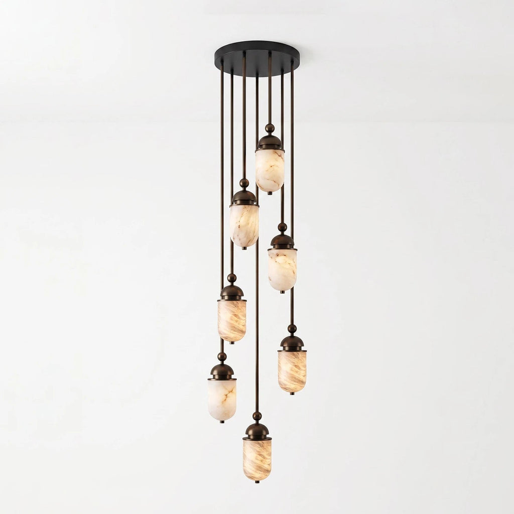 This Clérachic pendant's alabaster capsules stagger down from a round canopy, shown glowing against a plain backdrop.