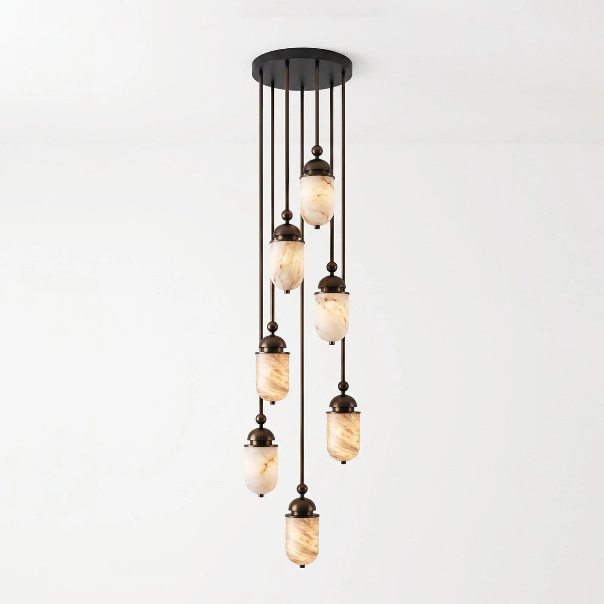 This Clérachic pendant's alabaster capsules stagger down from a round canopy, shown glowing against a plain backdrop.