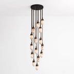 A dense cluster of glowing alabaster capsules on dark bronze rods makes up this Clérachic pendant, shown on white.