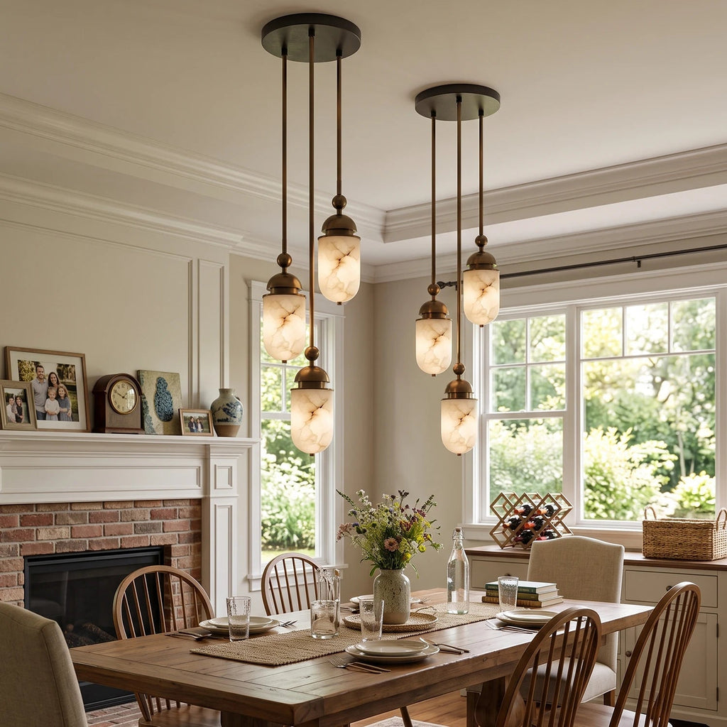 In a bright bay-window dining room with a brick hearth, this Clérachic pendant's alabaster capsules glow warm overhead.