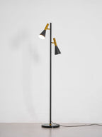 Black Clérachic floor lamp shown alone on a plain white studio background, its own shadow cast beside it.