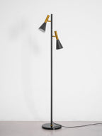 Black Clérachic floor lamp on a round marble base, photographed alone on a plain white studio backdrop.
