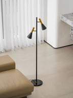The same marble-pillared wall backs a beige leather lounge and a black and brass Clérachic floor lamp nearby.