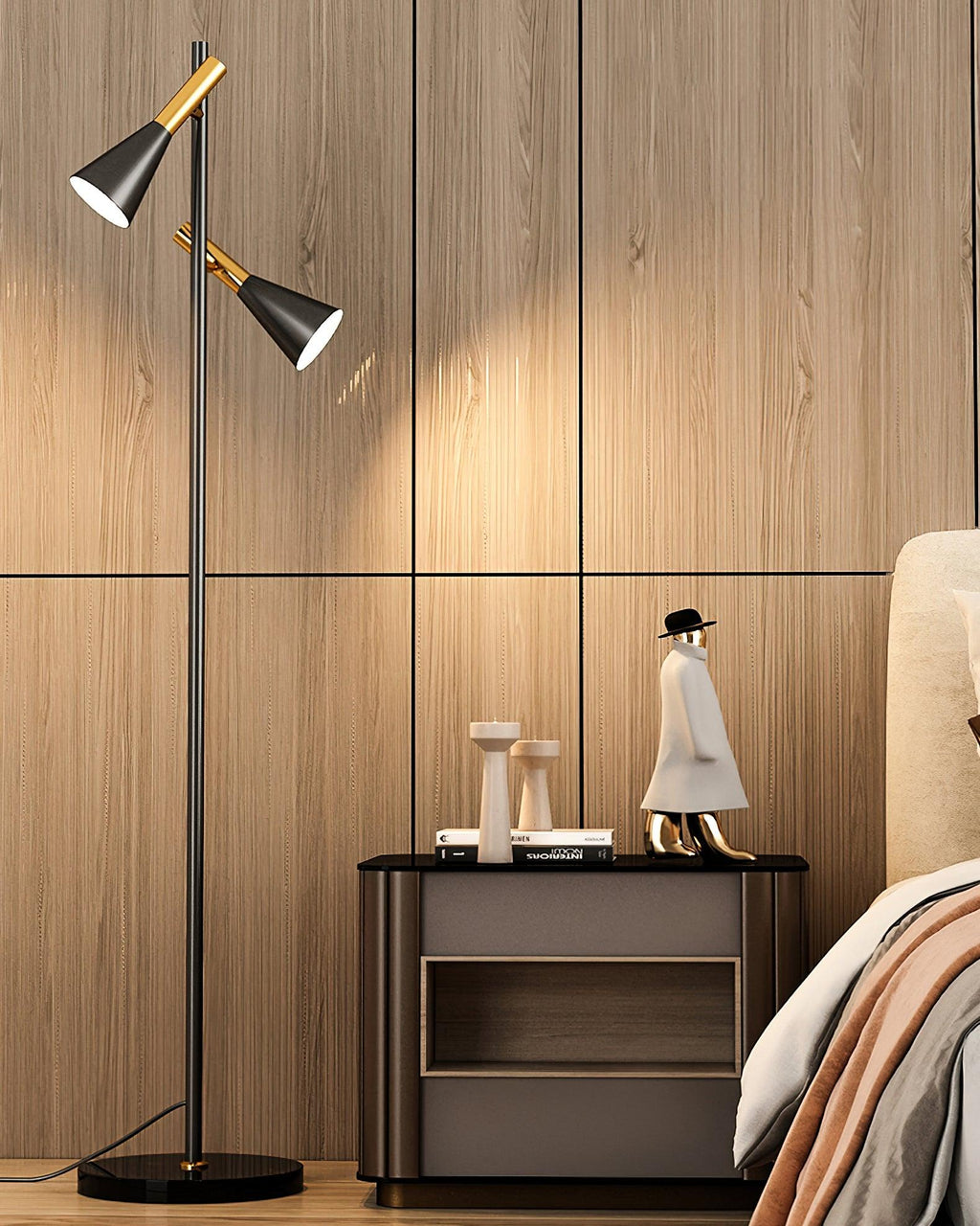 A small sculpture tops a wood nightstand beside a black and brass Clérachic floor lamp in a panelled bedroom.