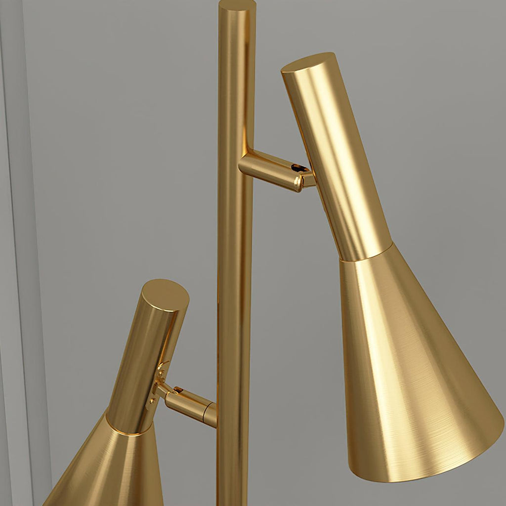 Macro view of both shade heads and swivel joints on an all-brass Clérachic floor lamp against a plain background.