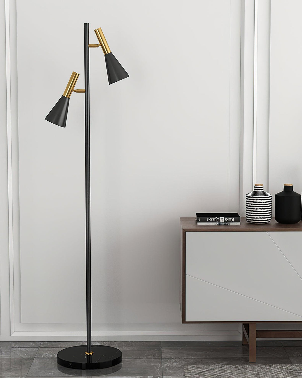 Bowls and vases fill a wood console table against a white wall beside a black and brass Clérachic floor lamp.