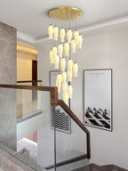 Sylirion descending a stairwell with a wood-and-glass handrail, next to a framed architecture print