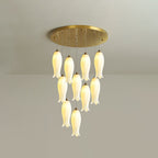 Ten-light Sylirion in the shorter drop, its bell-shaped ceramic shades clustered close to the ceiling