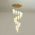 Sixteen-light Sylirion at full drop, a slow spiral of lit ceramic shades suited to a stairwell