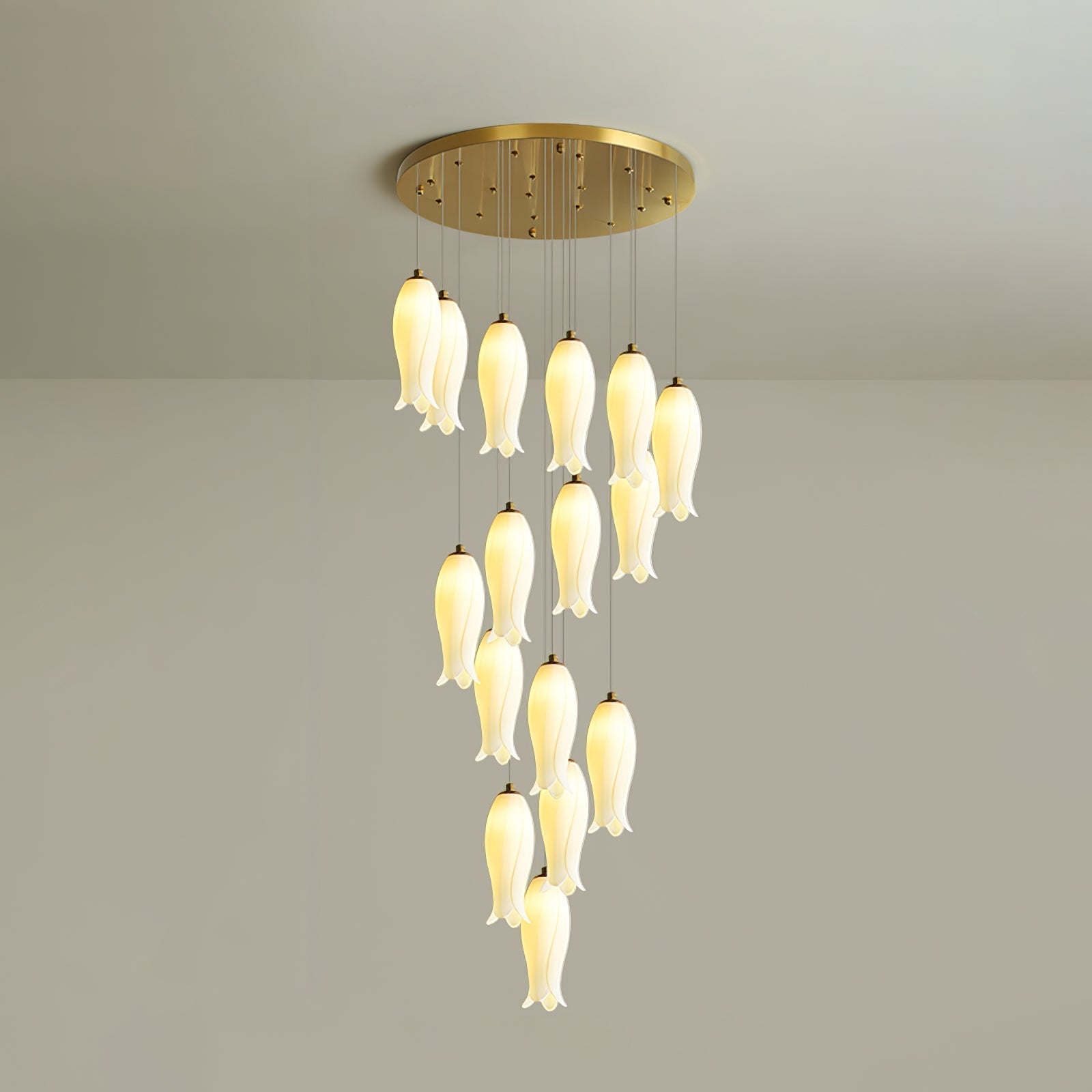 Sixteen-light Sylirion at full drop, a slow spiral of lit ceramic shades suited to a stairwell