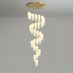 Sylirion lit against a grey studio wall, shades spiralling down from the round gold ceiling plate