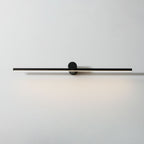 Studio shot of a Clérachic wall light glowing warm, front view against a plain white backdrop.