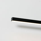 Close angled view of this Clérachic wall light's bar profile, its edge glowing warm.