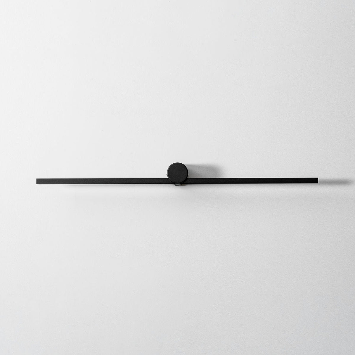 Studio shot of an unlit Clérachic wall light, shown front-on against a plain grey backdrop.