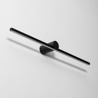 Angled studio view of a Clérachic wall light's round wall-mount bracket, unlit, with its fixing screw visible.