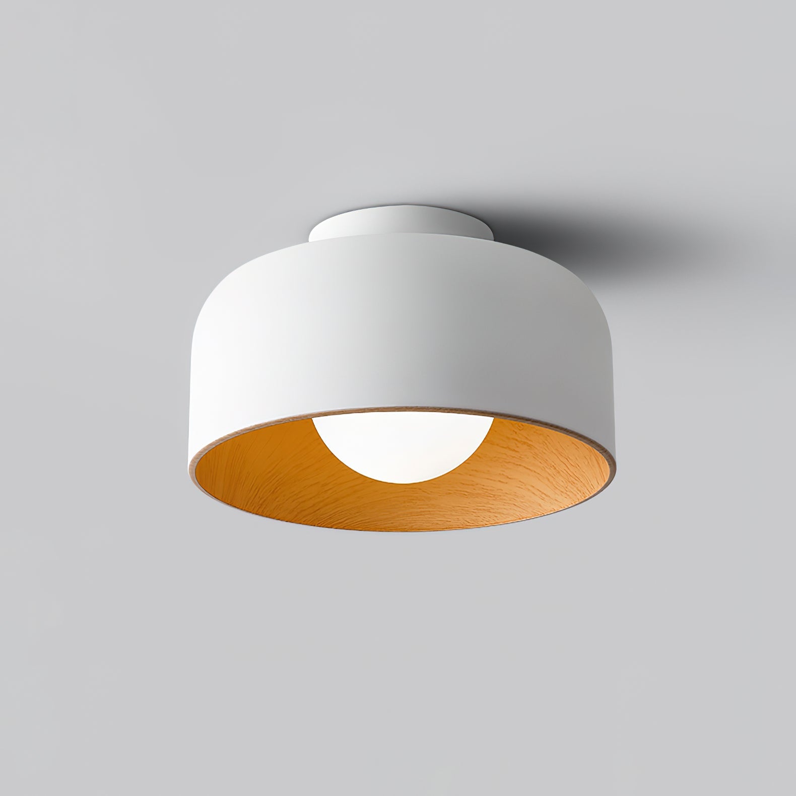 White glass globe ceiling light against neutral wall