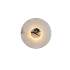 Close-up of a Clérachic alabaster wall light with a mottled brown-black centre disc set into the pale alabaster ring.