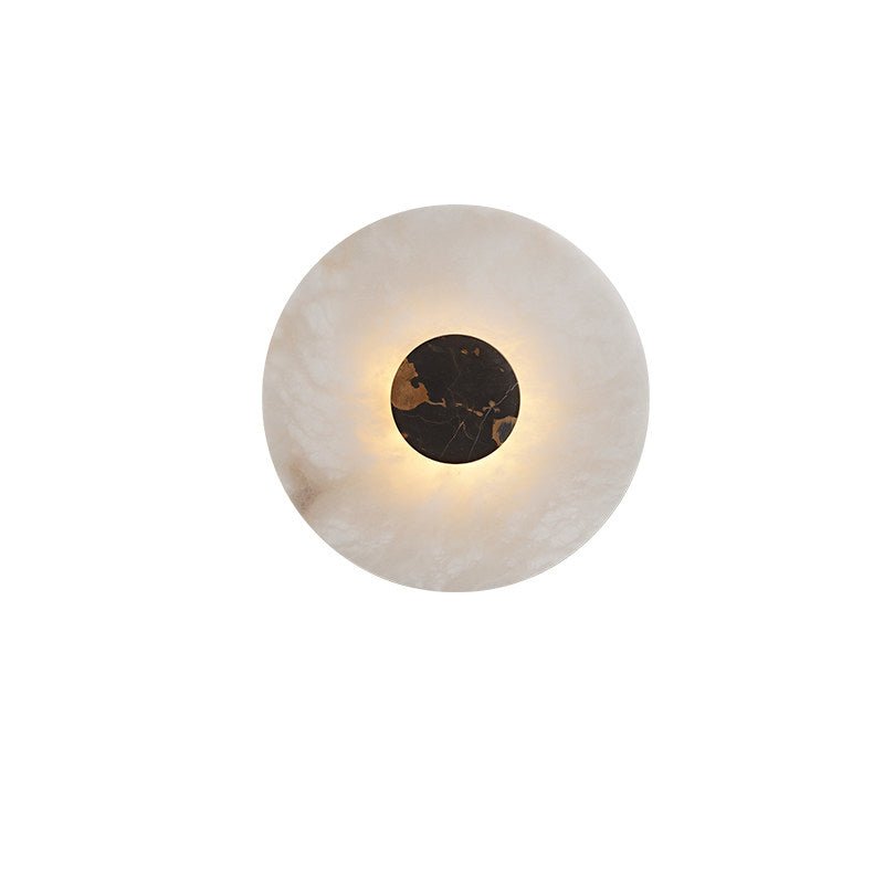 The black and orange marbled centre disc sits within the pale ring of this Clérachic alabaster wall light.