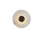 The black and orange marbled centre disc sits within the pale ring of this Clérachic alabaster wall light.