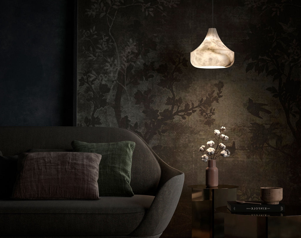 Tyler pendant glowing warm above a brass side table in a dark living room with a botanical mural wall.