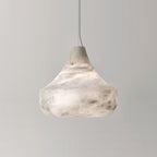 Square studio view of the Tyler pendant unlit, its bell-shaped alabaster shade against a plain pale grey wall.