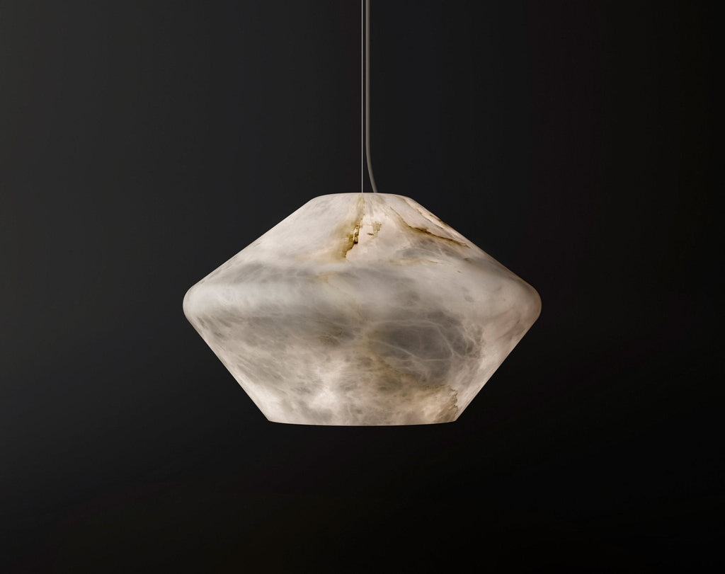 Faceted gem-shaped alabaster shade of the Tyler pendant on a dark background, a natural crevice visible at its top.
