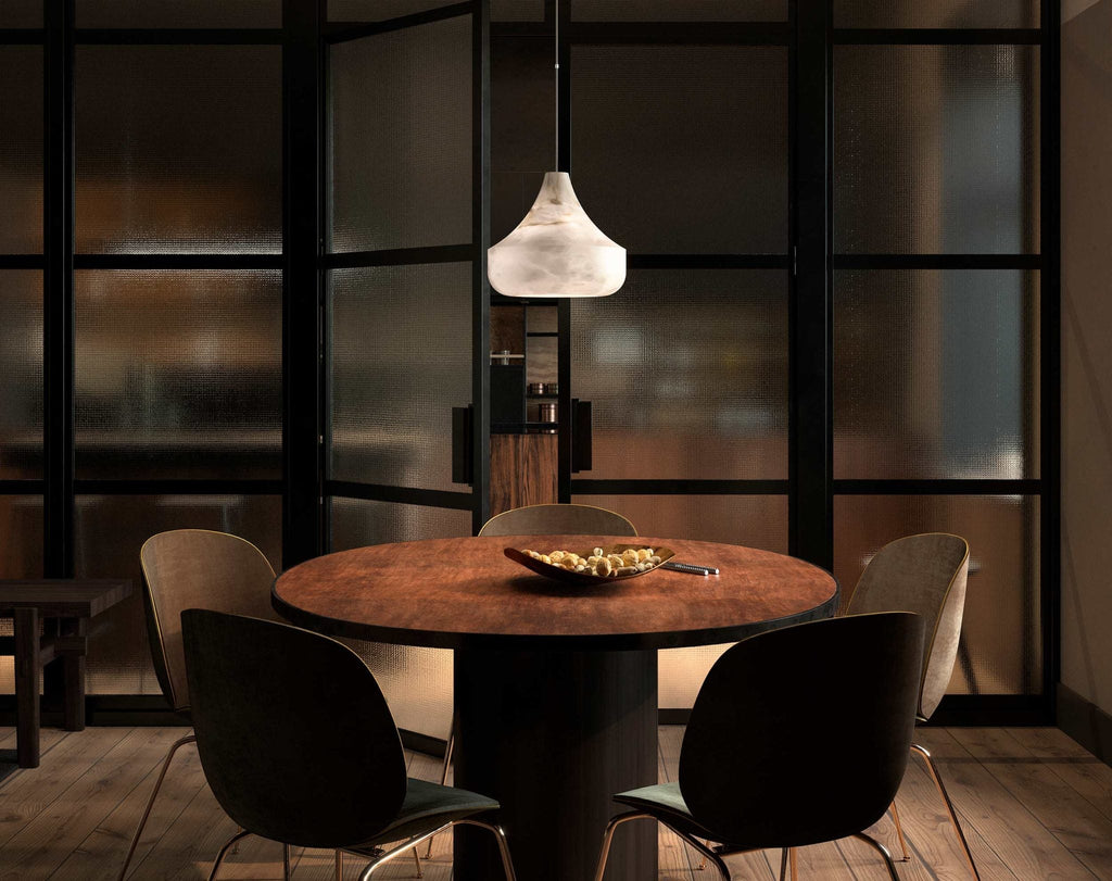 Eye-level view of the Tyler pendant lit over a round dining table, framed by a black-framed glass partition.