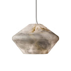 Close crop of the Tyler pendant's faceted alabaster shade on white, filling the frame to show its stone veining.