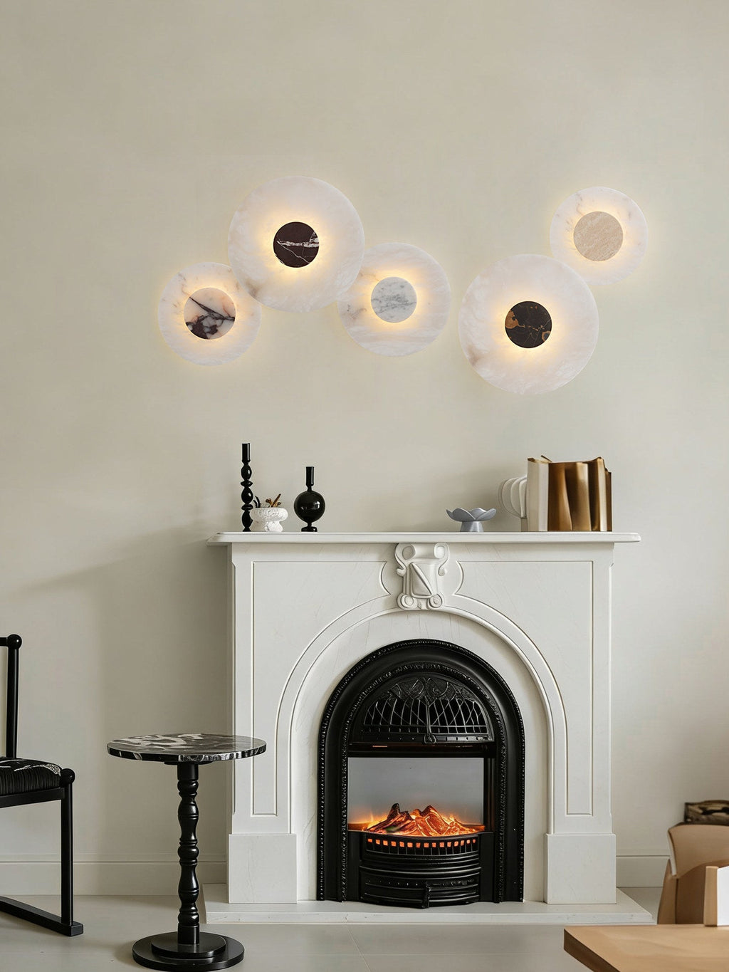 Five Clérachic alabaster disc wall lights cluster above a white fireplace mantel, each with a different marbled centre stone.