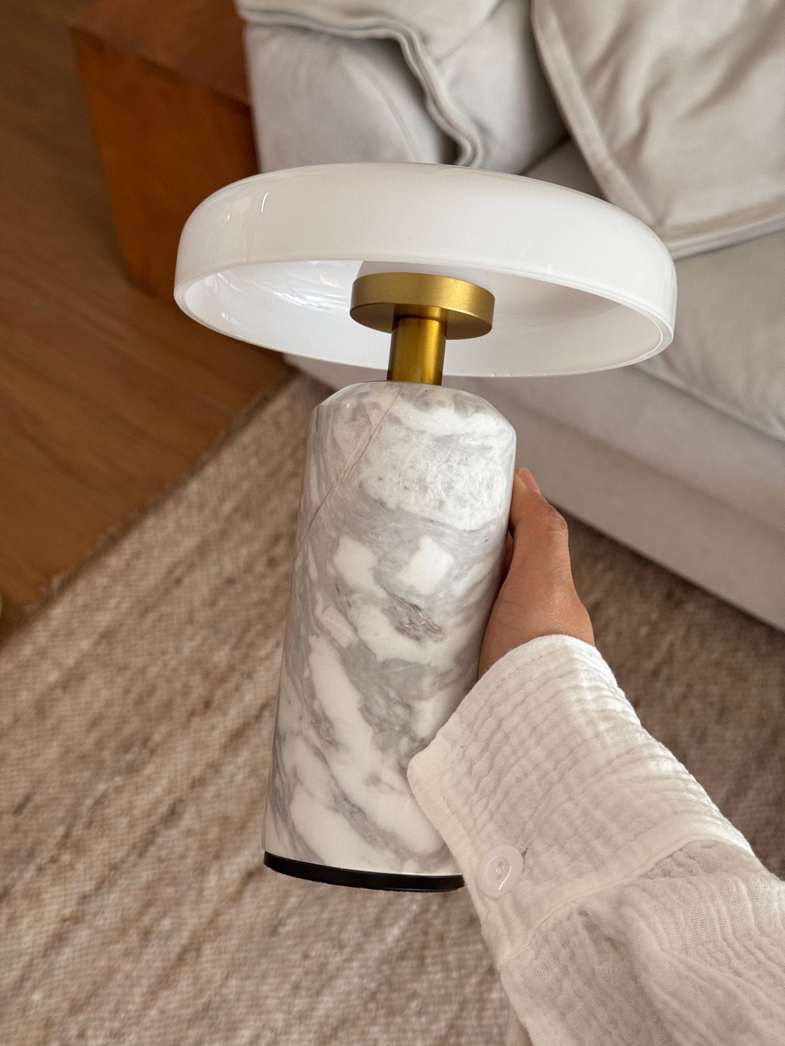 Opaline glass shade lamp lit on a marble base