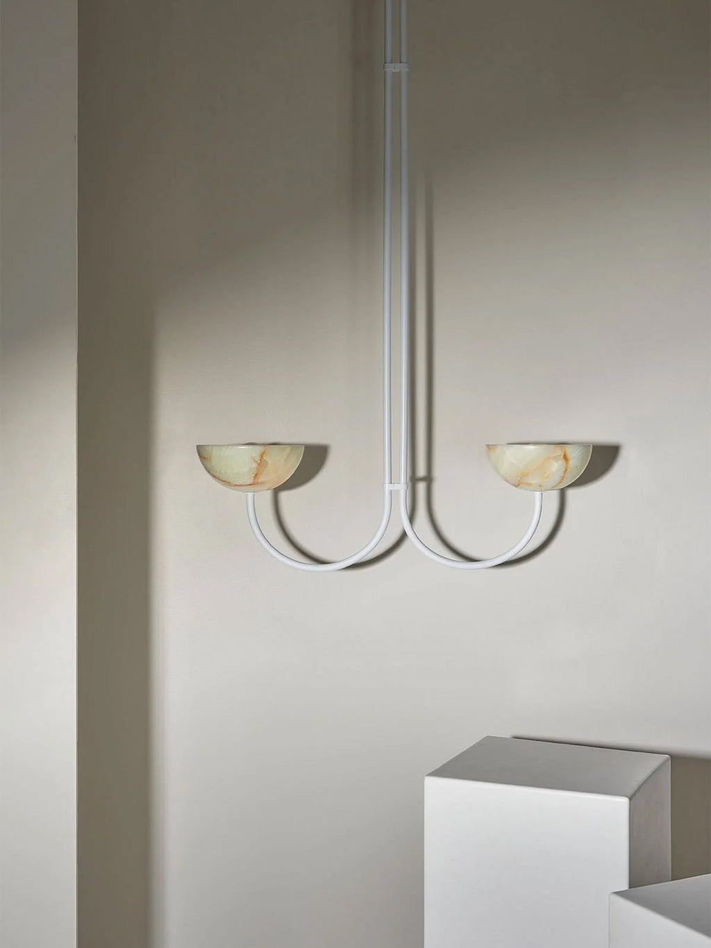 Clérachic white-finish Lunaris pendant with jade bowls in a room setting, arms curving out from a slim white stem.