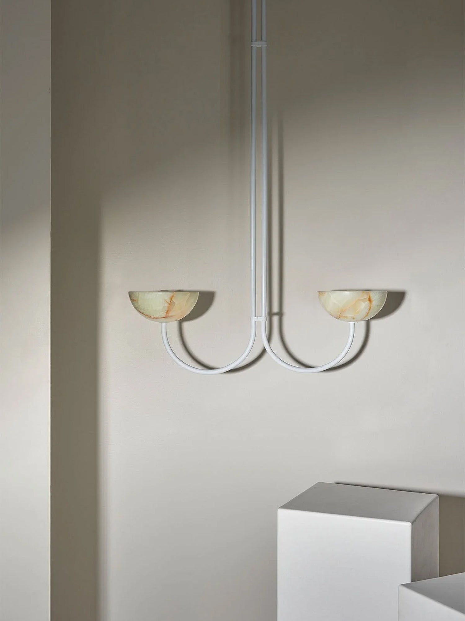 Clérachic white-finish Lunaris pendant with jade bowls in a room setting, arms curving out from a slim white stem.